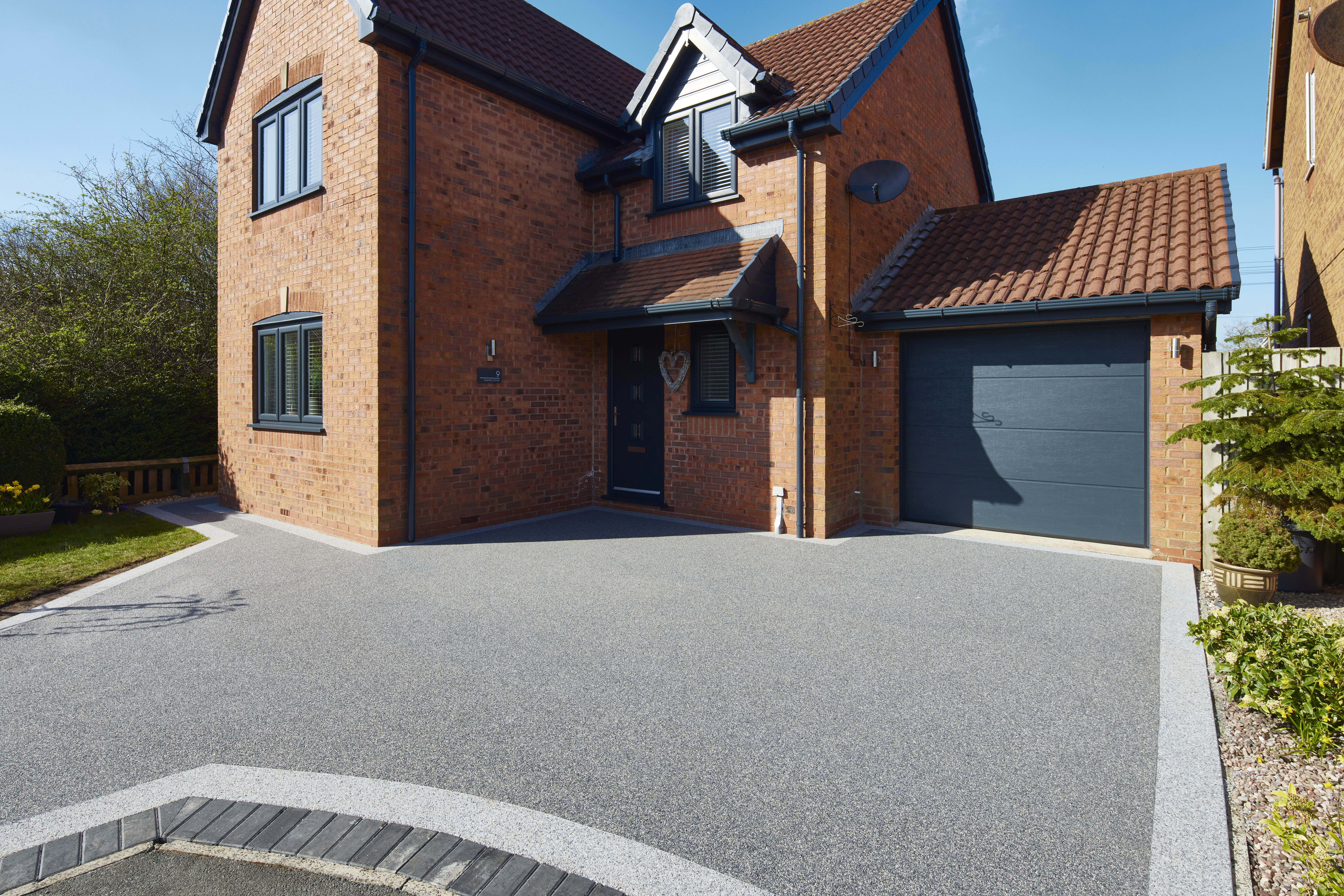 Modern resin driveway with grey aggregate finish